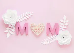 Pink 'MOM' with flowers on pink background.
