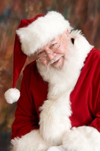 Smiling Santa Claus in red suit.