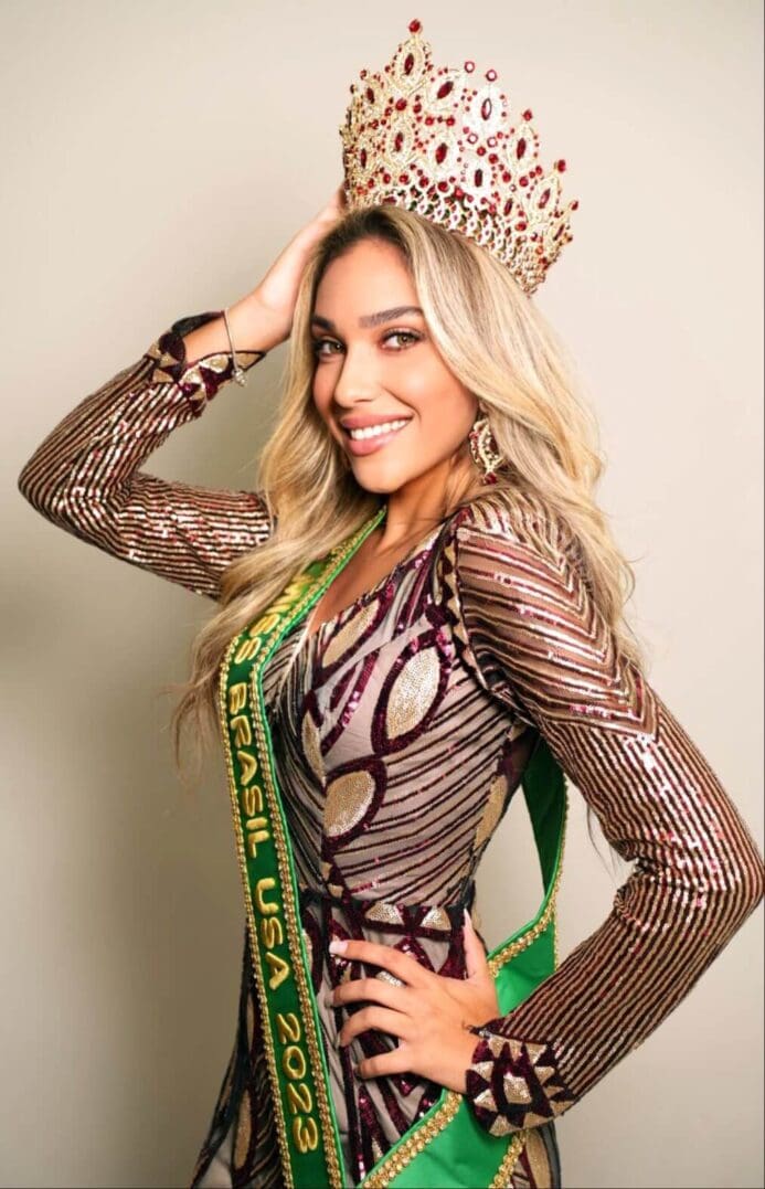 Beauty queen wearing a crown and sash.