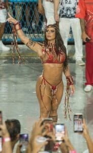 Carnival dancer in red costume performing.