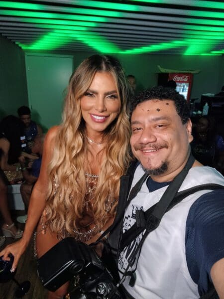 Man and woman smiling at an event.