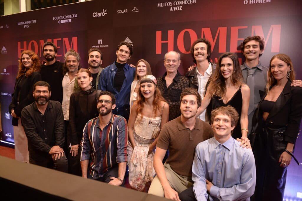 Group photo of cast and crew at a movie premiere event.