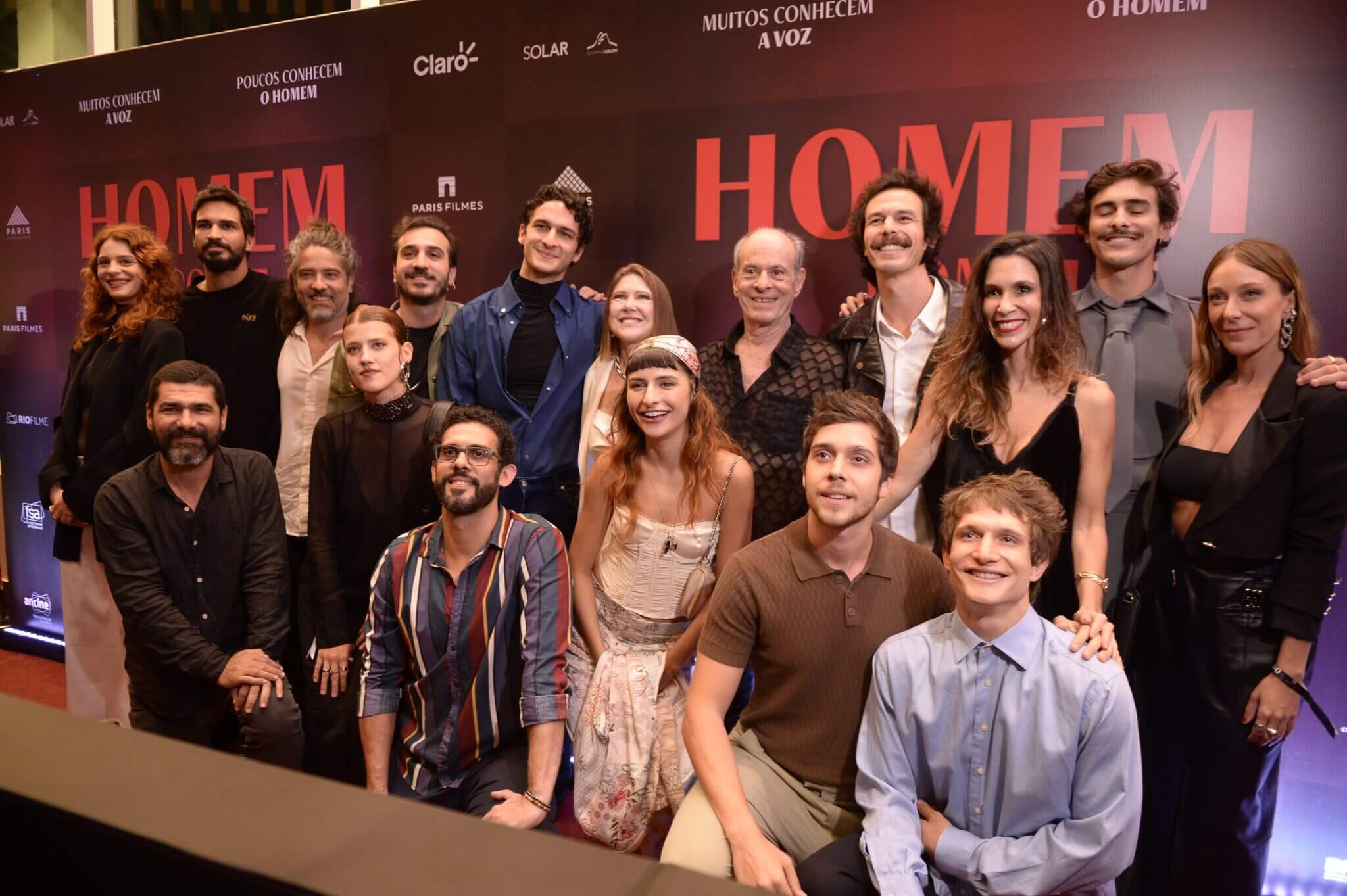 Group photo of cast and crew at a movie premiere event.