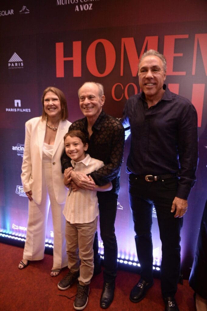 A family posing happily at a formal event with a purple backdrop.