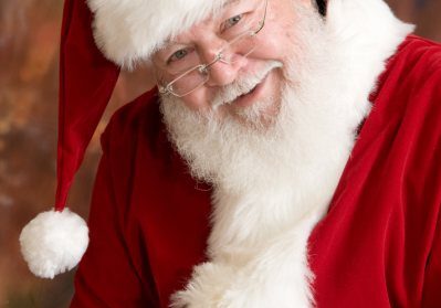 Smiling Santa Claus in red suit.