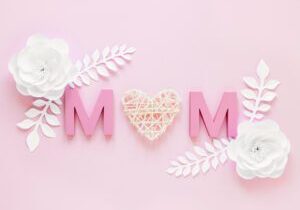 Pink 'MOM' with flowers on pink background.