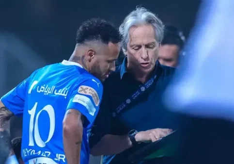 Soccer player and coach discussing strategy.