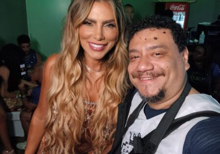 Man and woman smiling at an event.