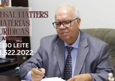 Man in office suit writing at desk.