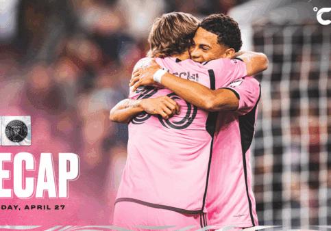 Soccer players hugging on the field.