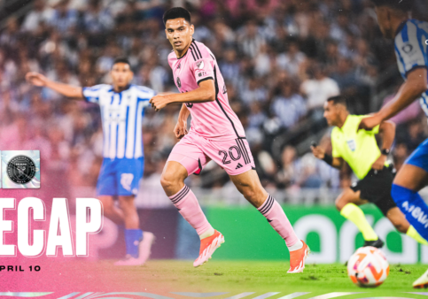 Soccer match action, pink and blue uniforms.