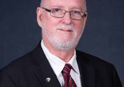 Man in suit with glasses and tie.